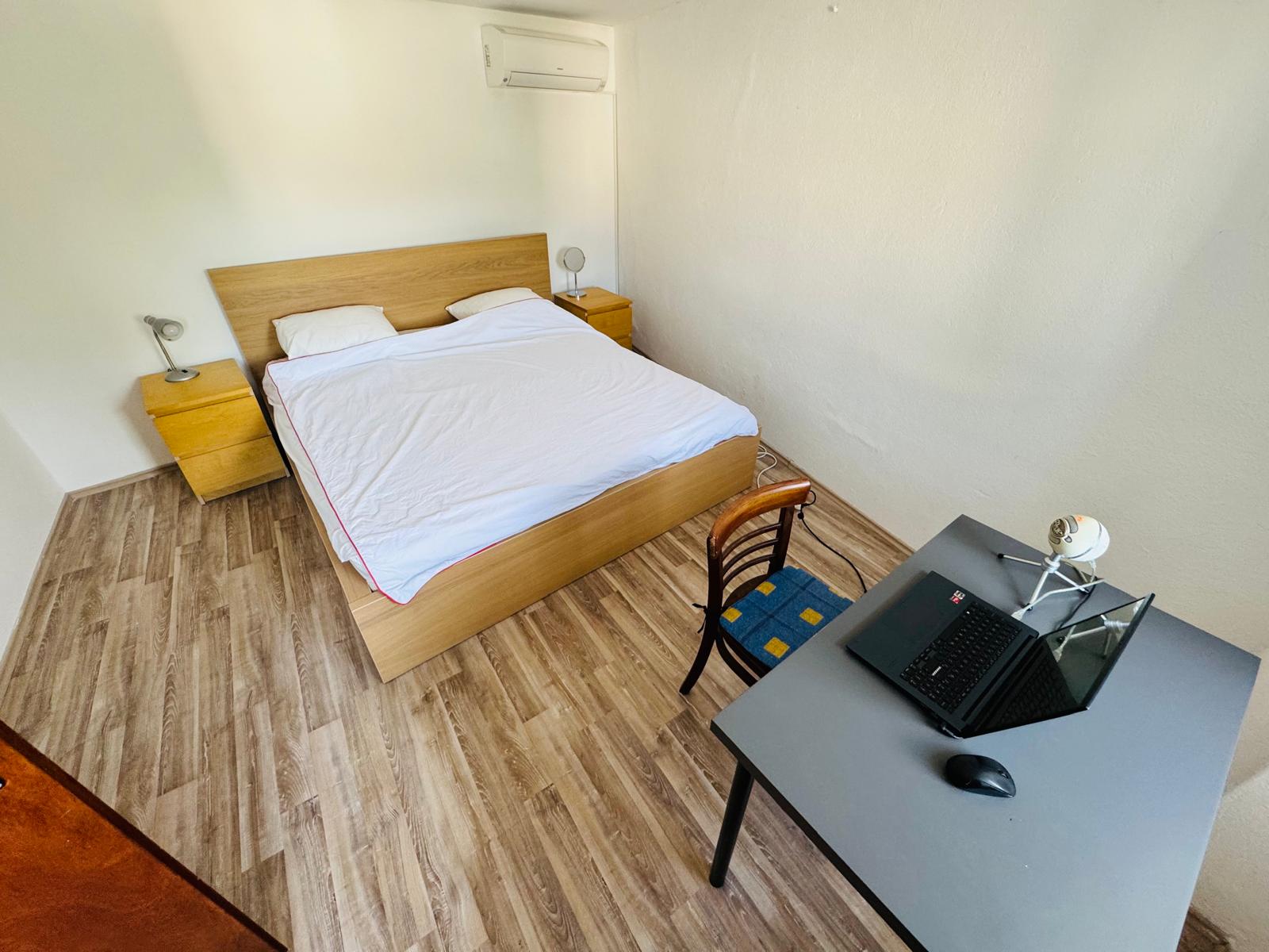 Bedroom with a quiet workspace and air conditioning